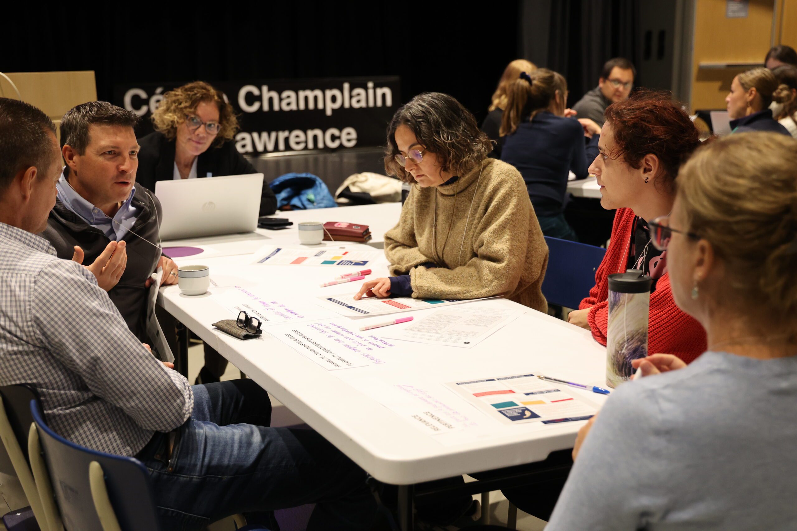 Employees sit around a table at a workshop